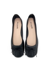 Black ballet flats with a textured leather upper, round toe, and a decorative bow. Smooth interior lining and minimalistic design details.