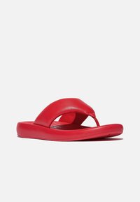 Rode leren slippers met een dikke, gebogen band en een platte zool. Gladde textuur met een minimalistisch ontwerp en geen zichtbare hardware.