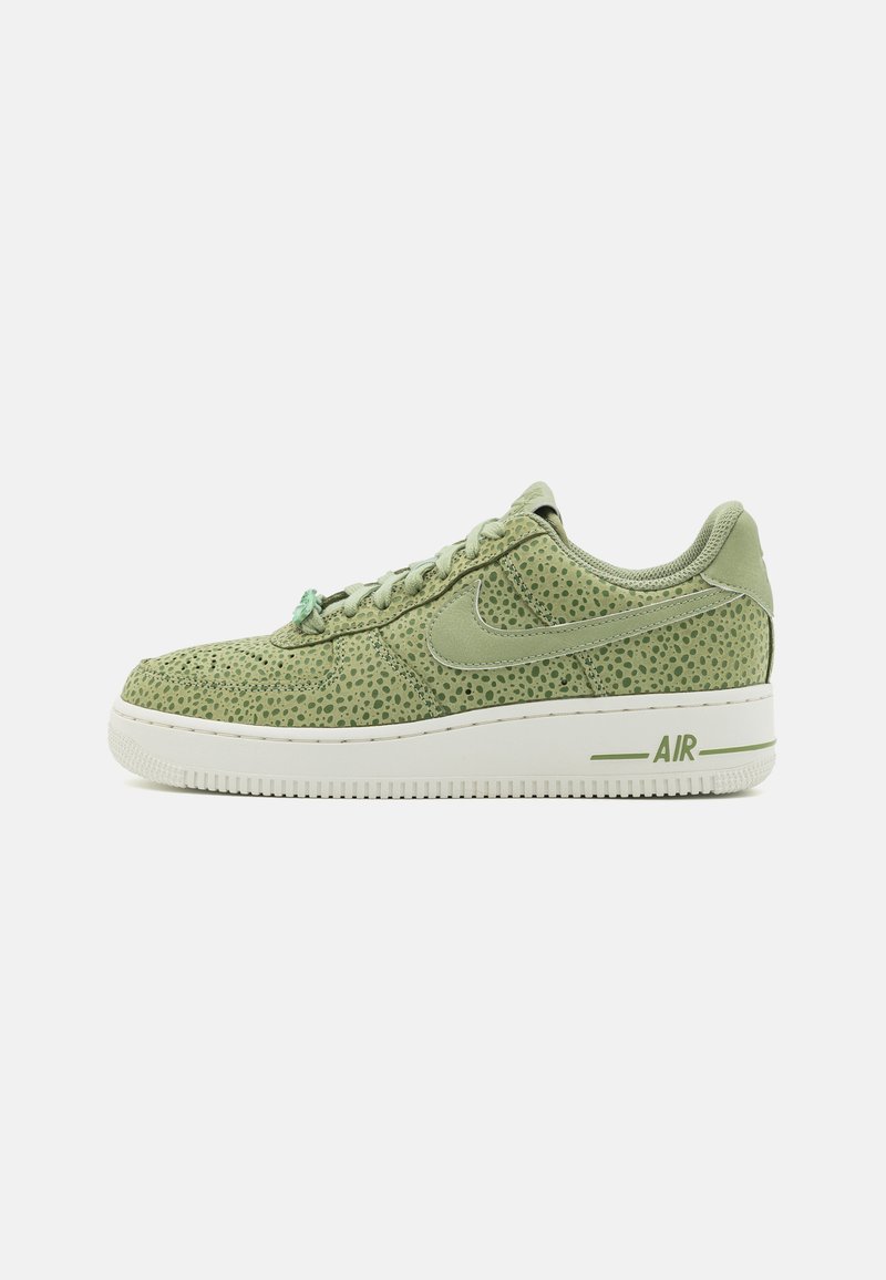 Groene sneakers met een gestructureerd oppervlak, voorzien van kleine stippenpatronen, een witte zool en een "AIR" logo op de hiel. Vetersluiting.