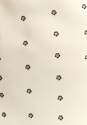 Kreemivärvi kangas, millel on väikesed, korduvatele mustritele mustad lillede kujutised. Pind on sile ja kerge läikega.