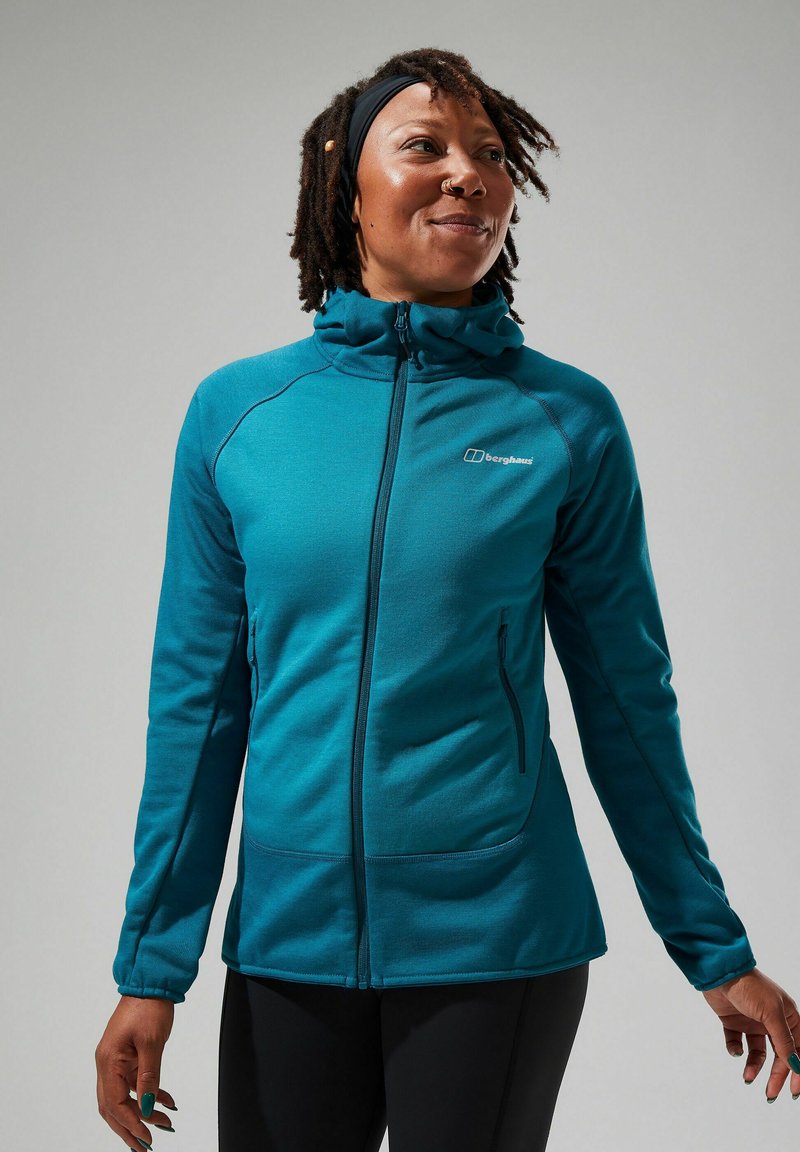 Veste en polaire teal avec fermeture éclair intégrale et capuche. Elle présente des poches latérales et des poignets élastiques, offrant un ajustement confortable et un bon maintien lors des activités de plein air.