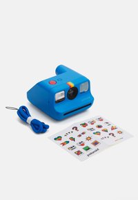 Polaroid camera in bright blue plastic, featuring a rainbow stripe, a red button, and two lenses. Includes a blue strap and sticker sheet.
