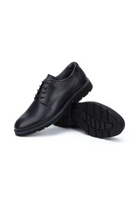 Chaussures habillées en cuir noir avec une finition lisse, un design à lacets, un bout rond et une semelle en caoutchouc texturée, ornées de coutures d'accentuation bleues.