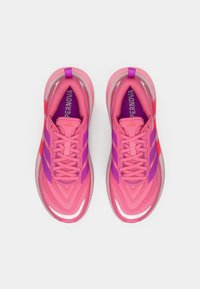 Pair of pink and purple Adidas running shoes with laces, viewed from above, on a white background.