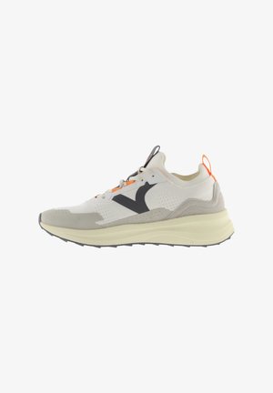 Lightweight running shoe in white and beige, featuring a black logo, orange accents, perforated fabric, and a cushioned, textured sole.