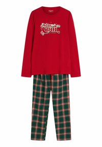 Czerwona bluzka z długim rękawem z nadrukiem „stay COOL”; zielone spodnie w kratę z czerwonymi i białymi liniami. Wykonane z bawełny, luźny krój, odpowiednie do noszenia w domu.