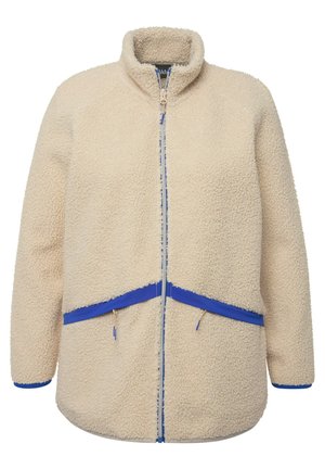 Giacca in pile color crema con colletto alto, dettagli blu, tasche con zip e superficie morbida e lavorata. Presenta una zip frontale.