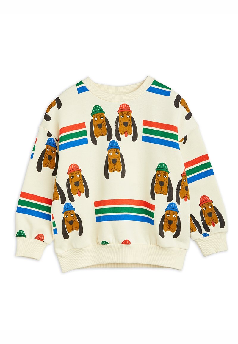 Sweatshirt couleur crème avec des visages de chiens répétés portant des chapeaux rouges, verts ou bleus, et des rayures horizontales rouges, vertes et bleues sur le tissu.