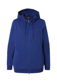 Felpa con zip di colore blu navy realizzata in tessuto morbido, dotata di cappuccio con coulisse, tasche laterali e polsini a costine per una vestibilità aderente.
