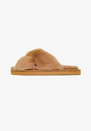 Tan fur slippers with a soft, fluffy texture, featuring a wide strap design and a textured sole. Rounded edges emphasize a cozy appearance.