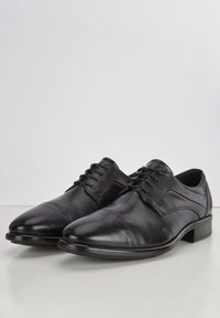 Scarpe eleganti in pelle nera con punta tondeggiante, texture liscia e lacci. Caratterizzate da un tacco basso e dettagli di cucitura discreti lungo i lati.