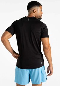 Schwarz kurzärmeliges Sportshirt mit glatter Textur und Rundhalsausschnitt. Hat drei kleine Punkte auf der Rückseite und ein Logo am Saum.
