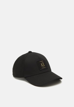 Casquette de baseball noire avec une visière incurvée et un patch carré avec le logo Armani Exchange en or et noir à l'avant.