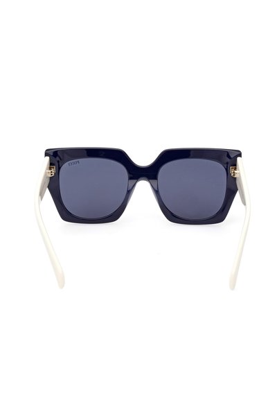 Navy blue oversized sunglasses with square lenses. White temples feature gold accents. Smooth plastic material, minimalistic design.