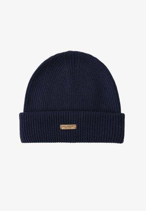 Navy ribbed knit beanie with a folded cuff and a small brown leather label featuring "BELLEMERE NEW YORK" embossed on it.