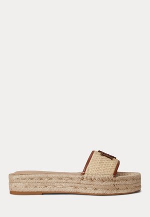 Sandale à plateforme tissée beige avec bordure marron et boucle décorative, dotée d'une semelle épaisse en jute tressé.