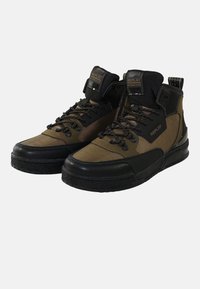 Zapatillas altas hechas de materiales sintéticos en tonos marrón y negro. Cuentan con una suela texturizada, cuello acolchado y puntera reforzada. Etiqueta "REPLAY" visible.