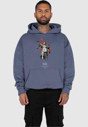Hooded sweatshirt in blue with a graphic of a female figure holding scales and a sword, surrounded by flames; features a front pocket.