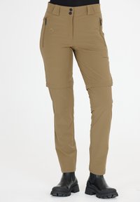 Pantalons de randonnée beige en tissu extensible, dotés de poches zippées, d'une fermeture à boutons et de poignets retroussables pour plus de polyvalence.