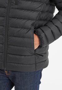 Black insulated puffer jacket with horizontal quilted design, zippered pockets, and elastic cuffs. Features a front zipper and smooth texture.