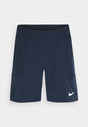 Short de sport bleu marine avec taille en mesh, poches latérales et logo blanc Nike swoosh sur la partie inférieure de la jambe droite.