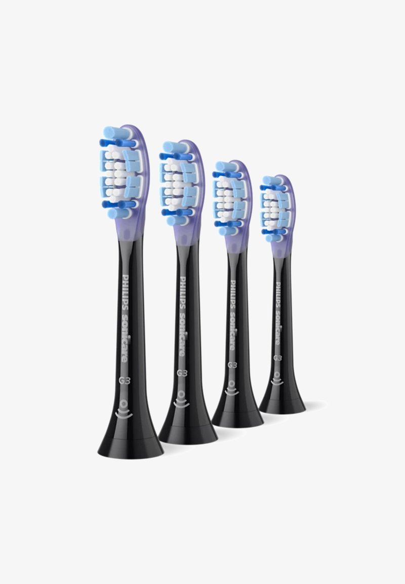 Quatre têtes de brosse à dents Philips Sonicare G3 noires avec des poils bleu-violet et un design incurvé, présentant une finition lisse et un étiquetage.