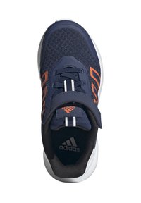 Zapatilla deportiva navy que cuenta con material de malla, acentos naranjas, una correa de Velcro y una suela de goma con acabado texturizado para mayor agarre.