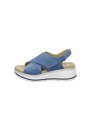 Blue suede sandal with cross-over straps, open toe, and adjustable back strap. Features a white platform sole with black accents.