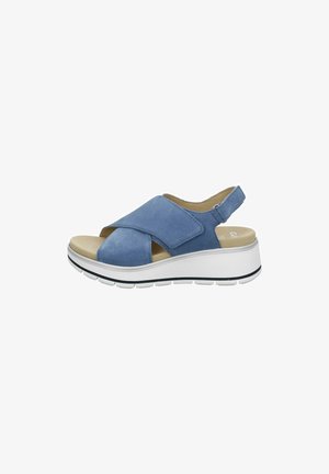 Blue suede sandal with cross-over straps, open toe, and adjustable back strap. Features a white platform sole with black accents.