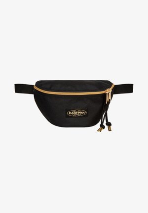 Riñonera Eastpak negra con cremallera dorada y logo, con dos tiradores de cremallera con cordones negros y puntas doradas.