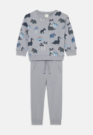 Gray children's sweat outfit featuring a long-sleeve top with dinosaur prints in blue and black, paired with matching jogger pants with drawstring.