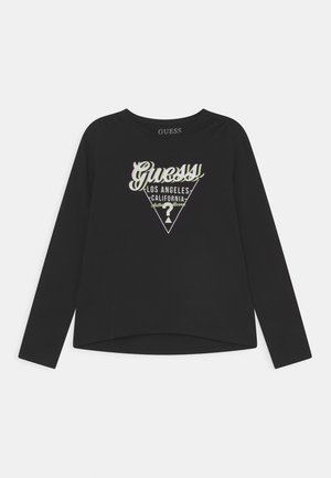 Chemise noire à manches longues avec logo "Guess" et texte "Los Angeles California" à l'intérieur d'un triangle au centre devant.
