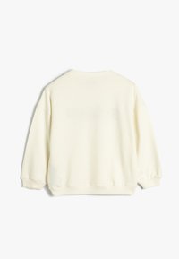 Ljus krämfärgad sweatshirt med rund halsringning, sänkt axel och ribbade muddar och fåll. Mjuk, texturerad tyg med en enkel design.