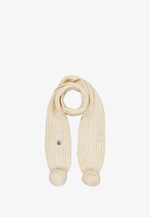 Bufanda de punto de color crema con un diseño texturizado, que presenta dos pompones suaves en cada extremo y una pequeña etiqueta con el logo.