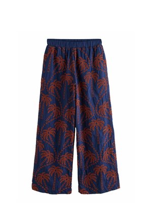 Pantalon large bleu marine avec ceinture élastique, arborant un motif intégral d'arbres de palmier orange avec des détails en pointillés.