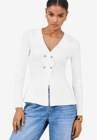 Cardigan alb cu manșete lungi, cu decolteu în V, având un design dublu cu nasturi aurii și un tiv evazat.