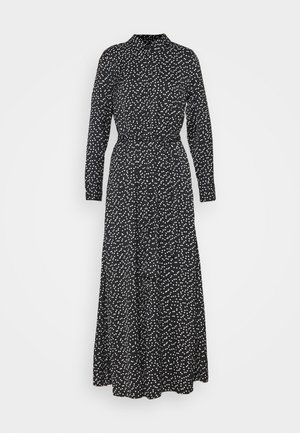 Schwarzes Maxikleid mit langen Ärmeln, weißem, unregelmäßigem Punktmuster, hohem Kragen, geknöpften Manschetten und einem gebundenen Taillengürtel.
