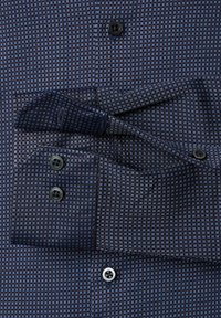 Marineblauwe button-up shirt met een ruitpatroon, voorzien van zwarte knopen en contrasterende lichtblauwe accenten op de kraag en manchetten.