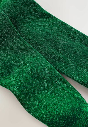 Tissu vert pailleté avec une surface texturée, présentant une finition chatoyante. Le matériau est doux et montre un gros plan du tissage.