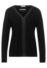 Top nero a maniche lunghe con scollo a V caratterizzato da una striscia verticale centrale in argento metallico e la scritta "GLOWING" all'altezza del collo.