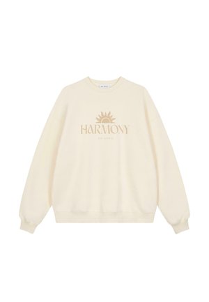Cremefarvet sweatshirt lavet af blødt stof, med rund hals, lange ærmer og et centralt solgrafik med teksten "HARMONY".