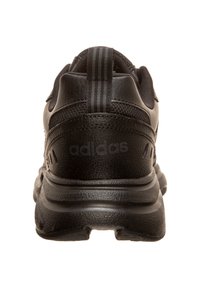 Black athletic shoe featuring a textured leather upper, a padded collar, and a rubber outsole. "adidas" logo on the heel.