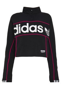 Svart kortärmad sweatshirt med hög krage, med framträdande vit Adidas-logotyp, rosa detaljer längs sömmarna och randiga ärmslut.