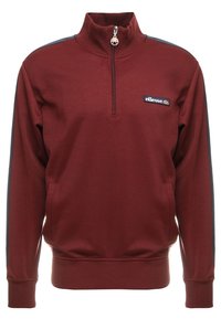 Bordeaux kwart-rits sweatshirt met zwarte strepen op de mouwen en ellesse logo patch op de linkerborst.
