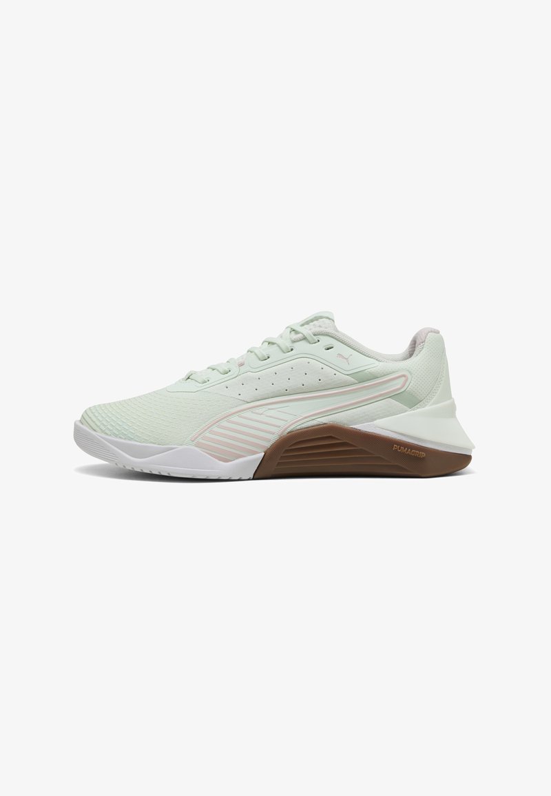 Light green athletic shoe with a textured upper, white accents, and a brown rubber sole. Features breathable mesh and reinforced toe.