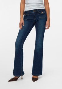 Dark blue flared jeans made from denim, featuring front and back pockets with copper hardware, a fitted waist, and a smooth texture.