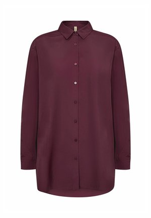 Burgundijas pogām augšā krekls, izgatavots no gludas auduma. Iekļauj klasisku apkakli, garas piedurknes un nedaudz izliekts apakšmala. Minimālistisks dizains.