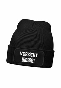 Black knitted beanie with a thick rim, featuring a rectangular patch labeled "VORSICHT BISSIG!" in bold white text on the front.