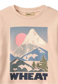 Hellrosa T-Shirt mit einem Bergmotiv, einem pinken Sonnenaufgang, blauen und grünen Bergen sowie dunkelblauem Text "WHEAT MOUNTAIN EXPLORE" am unteren Rand.