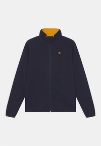 Námořnická fleecová bunda se zipem, vysokým límcem a žlutým vnitřkem. Na hrudi je logo a manžety jsou v kontrastní barvě.